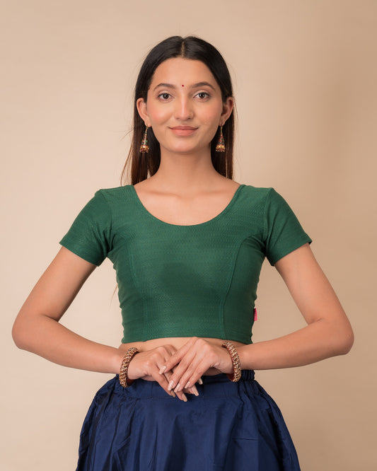 Model wearing a  stretchable dobby cotton blouse with half sleeves and round neckline