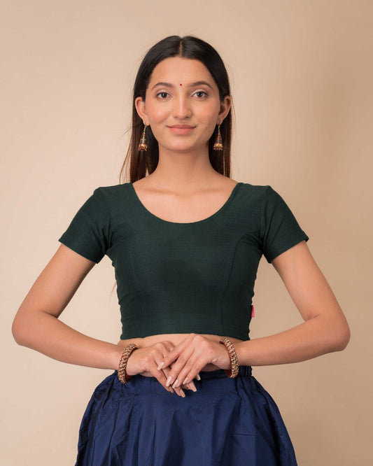 Model wearing a  stretchable dobby cotton blouse with half sleeves and round neckline