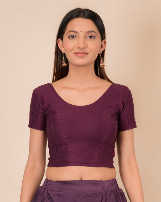 Model wearing a  stretchable dobby cotton blouse with half sleeves and round neckline
