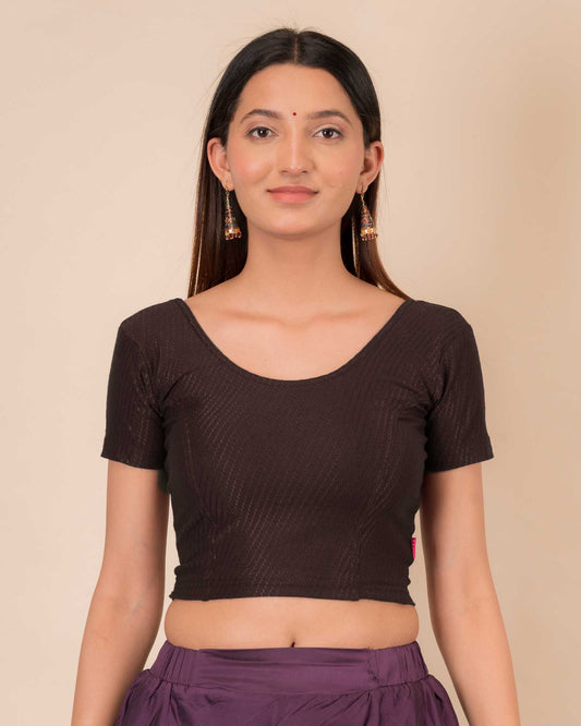 Model wearing a  stretchable dobby cotton blouse with half sleeves and round neckline