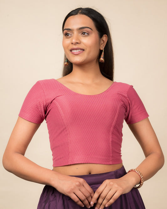 Model wearing a stretchable dobby cotton blouse with half sleeves and round neckline