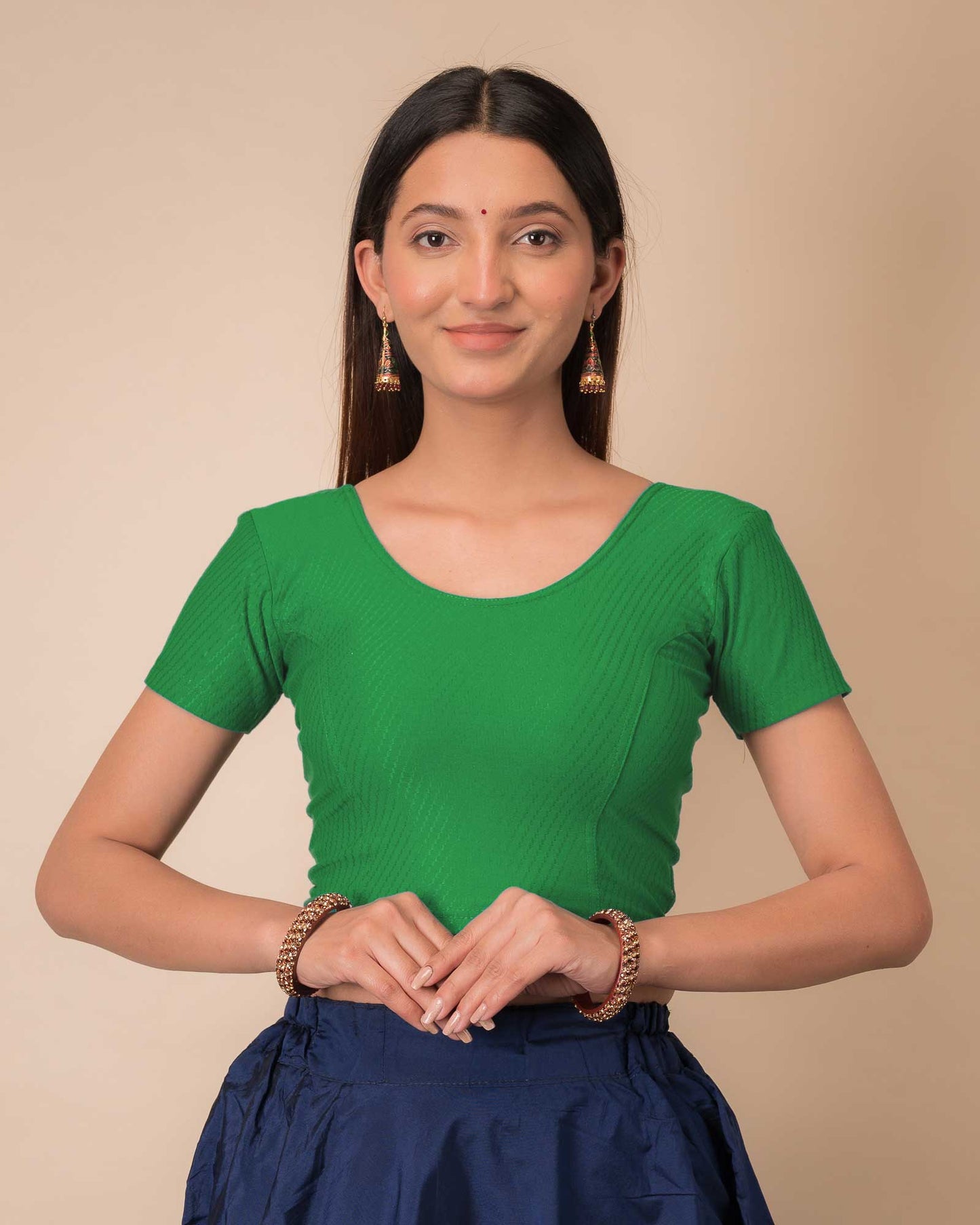 Model wearing a stretchable dobby cotton blouse with half sleeves and round neckline