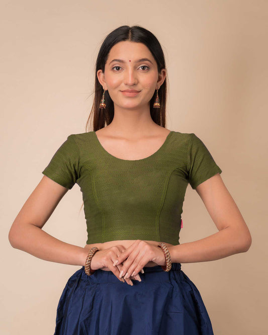 Model wearing a  stretchable dobby cotton blouse with half sleeves and round neckline