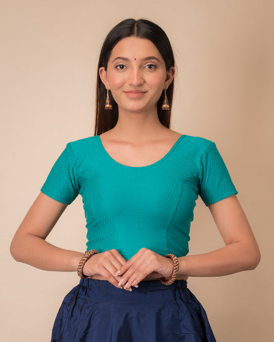 Model wearing a  stretchable dobby cotton blouse with half sleeves and round neckline