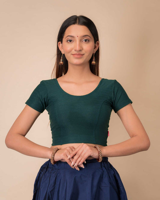 Model wearing a  stretchable dobby cotton blouse with half sleeves and round neckline