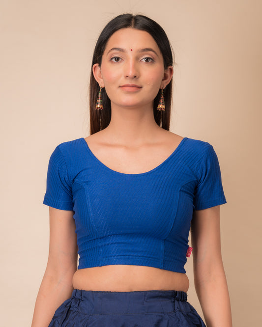 Model wearing a  stretchable dobby cotton blouse with half sleeves and round neckline