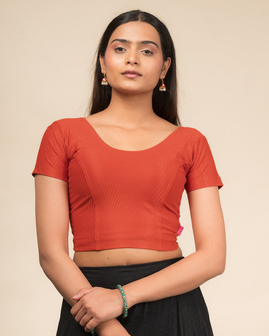 Model wearing a  stretchable dobby cotton blouse with half sleeves and round neckline