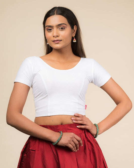 Model wearing a stretchable dobby cotton blouse with half sleeves and round neckline