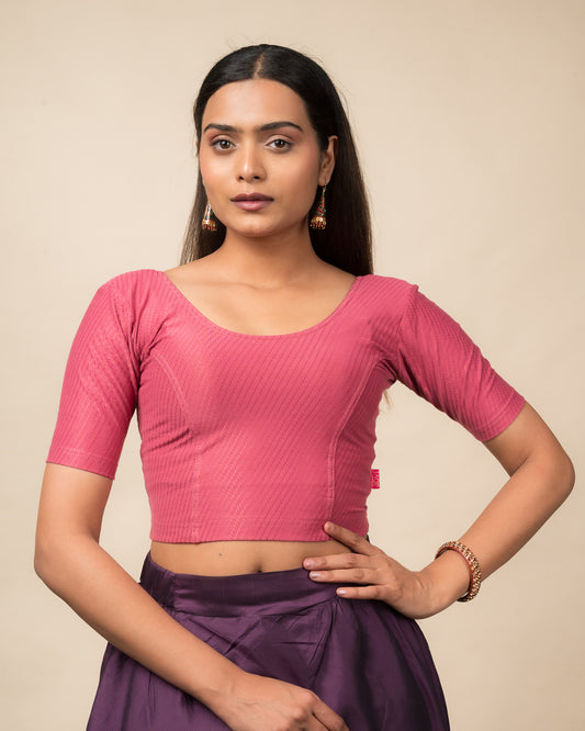 Model wearing a dobby cotton stretchable blouse with elbow sleeves and round neckline