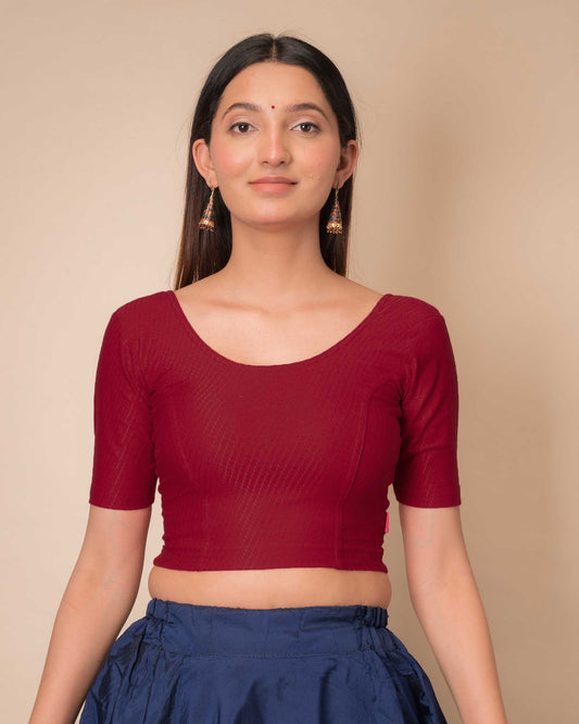 Model wearing a dobby cotton stretchable blouse with elbow sleeves and round neckline