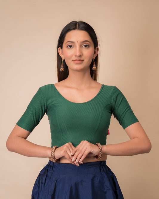 Model wearing a dobby cotton stretchable blouse with elbow sleeves and round neckline