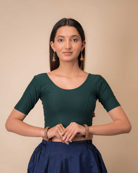 Model wearing a dobby cotton stretchable blouse with elbow sleeves and round neckline