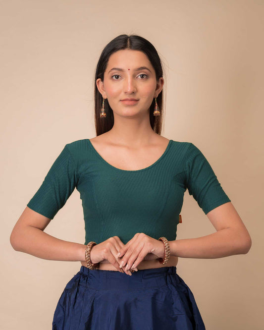 Model wearing a dobby cotton stretchable blouse with elbow sleeves and round neckline