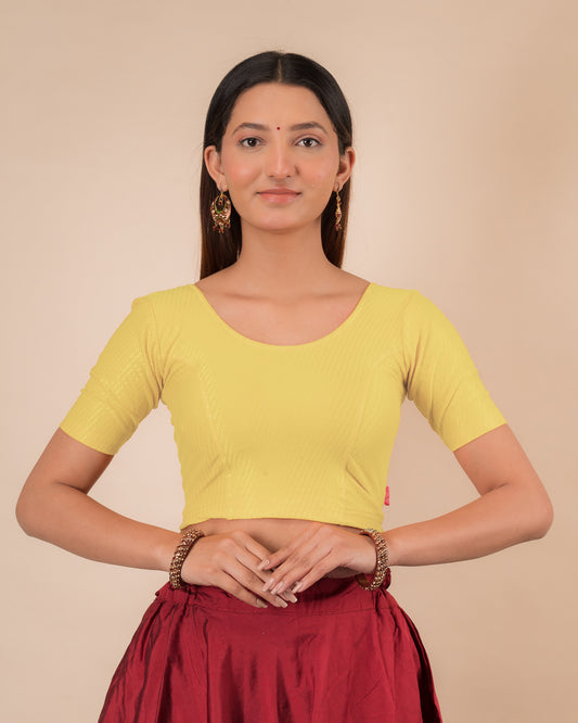 Model wearing a dobby cotton stretchable blouse with elbow sleeves and round neckline