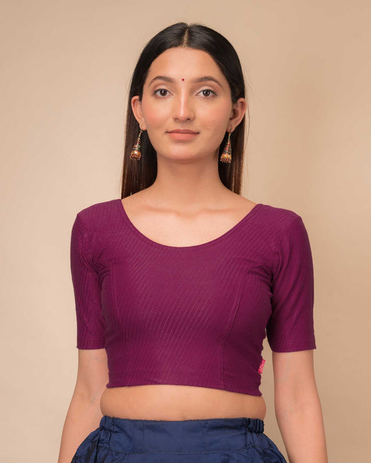 Model wearing a dobby cotton stretchable blouse with elbow sleeves and round neckline