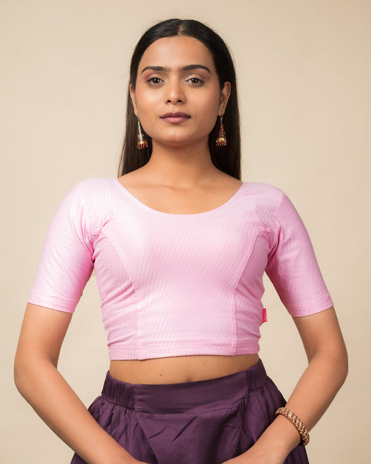 Model wearing a dobby cotton stretchable blouse with elbow sleeves and round neckline