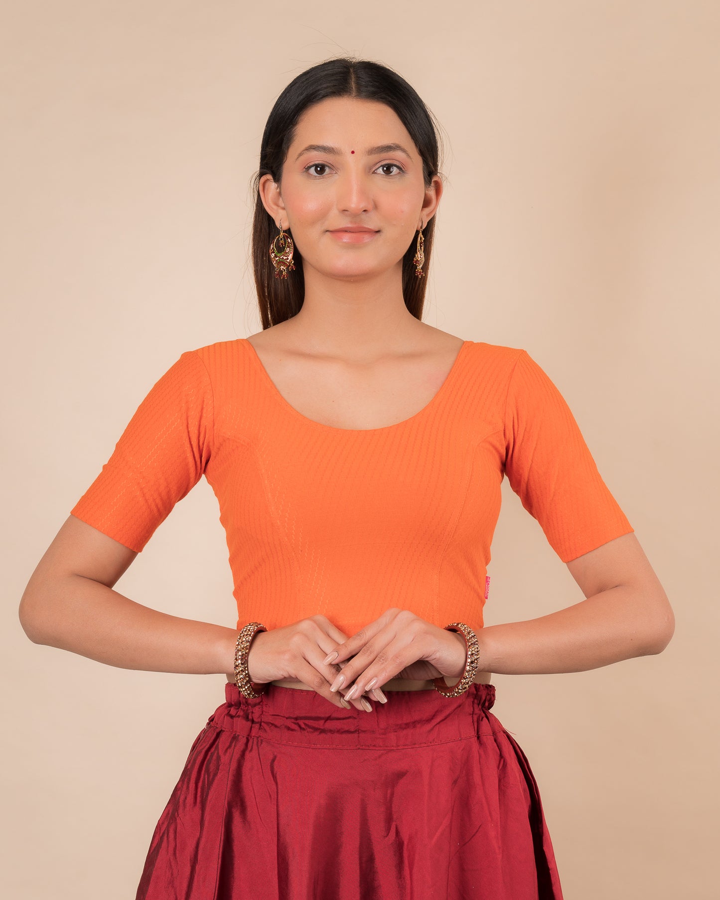 Model wearing a dobby cotton stretchable blouse with elbow sleeves and round neckline