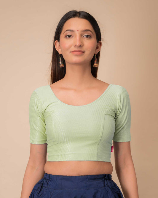 Model wearing a dobby cotton stretchable blouse with elbow sleeves and round neckline