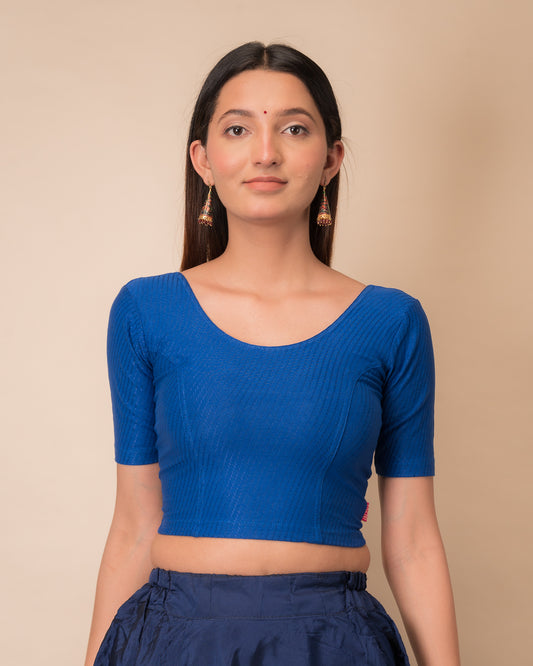 Model wearing a dobby cotton stretchable blouse with elbow sleeves and round neckline