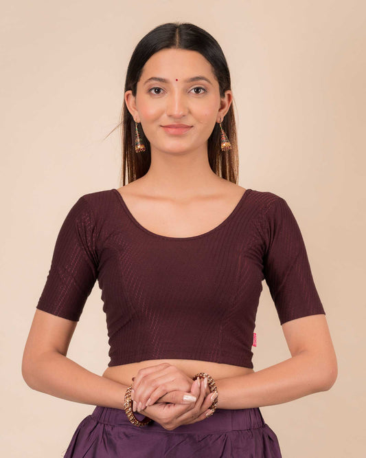 Model wearing a dobby cotton stretchable blouse with elbow sleeves and round neckline