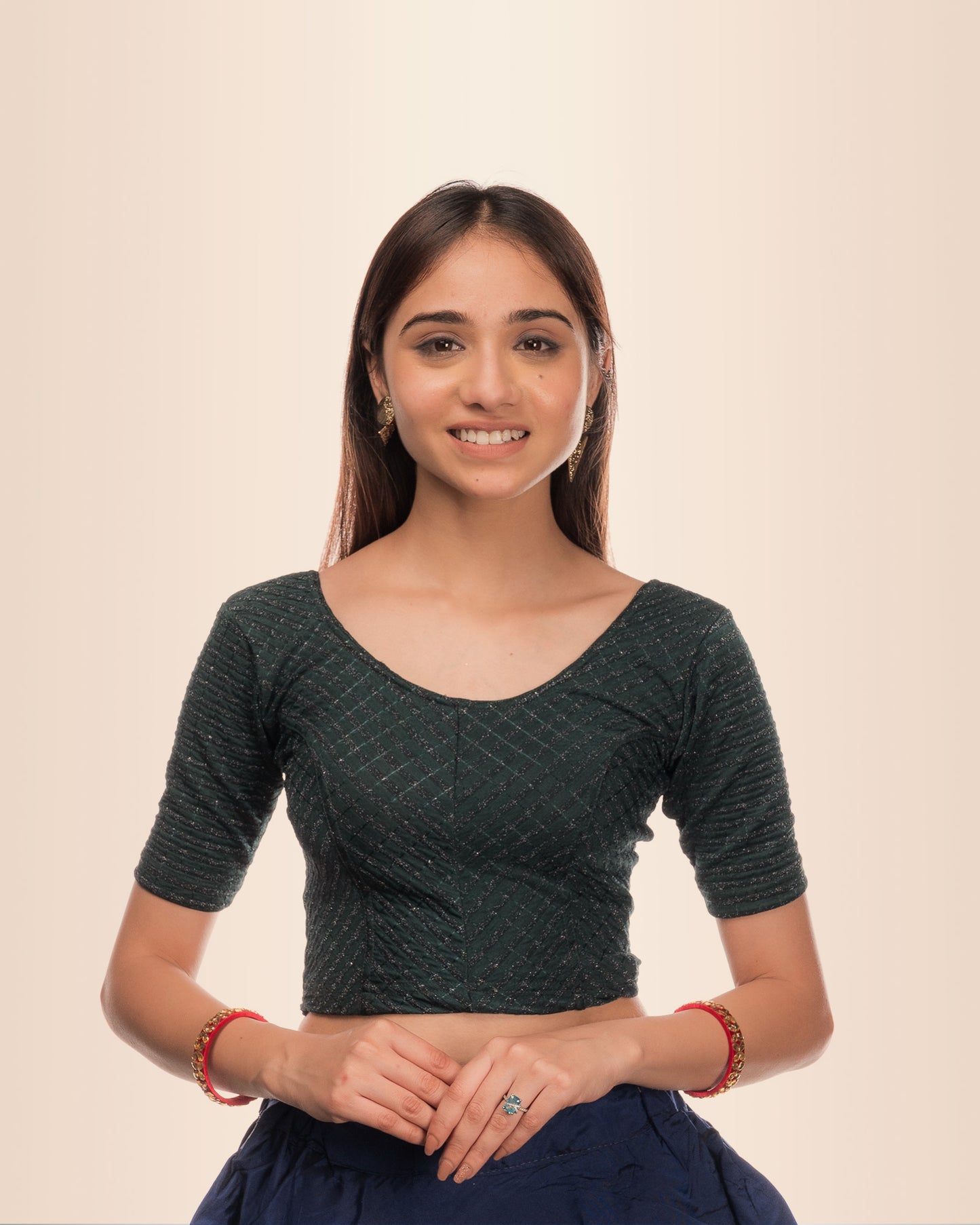 Model wearing a stretchable blouse with metallic zig‑zag stripes, elbow sleeves, and round neckline