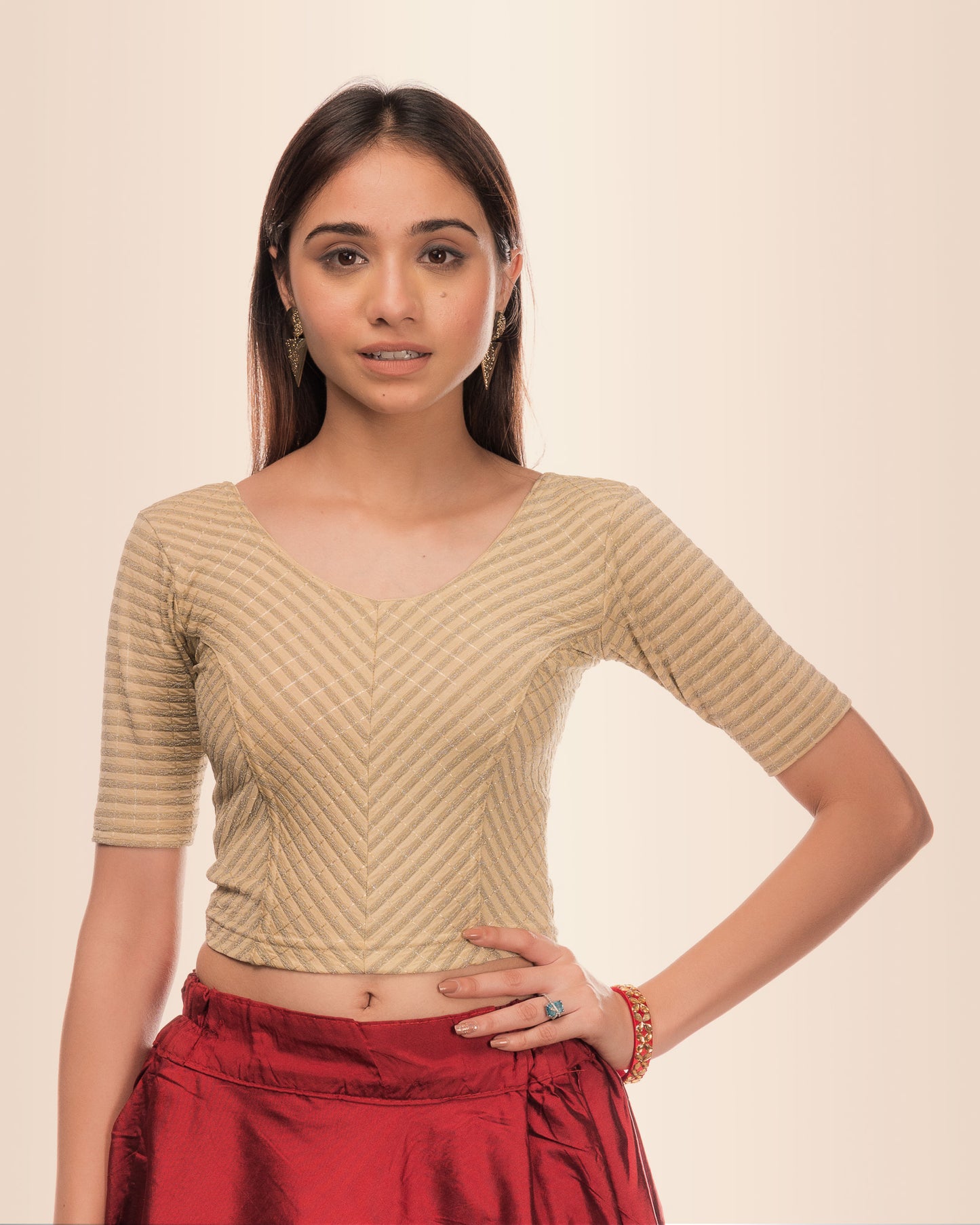 Model wearing a stretchable blouse with metallic zig‑zag stripes, elbow sleeves, and round neckline