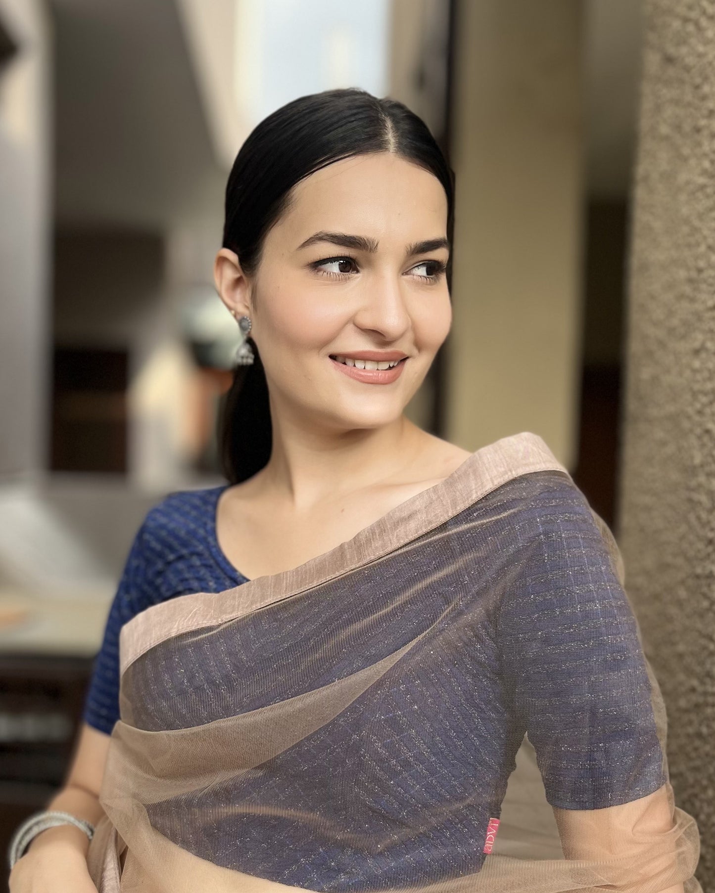 Model pairing the blouse with a saree for a bold, festive look.