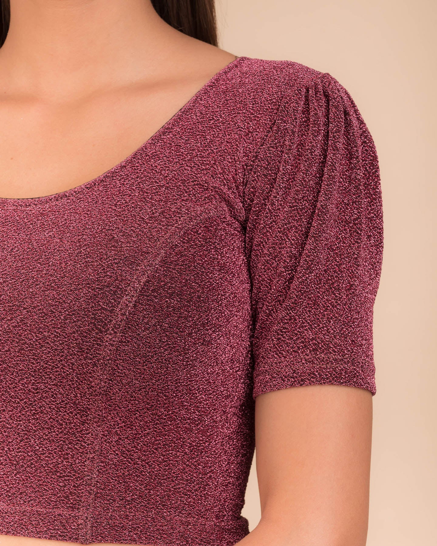 Close-up of the lurex fabric with fine pleating and subtle sheen