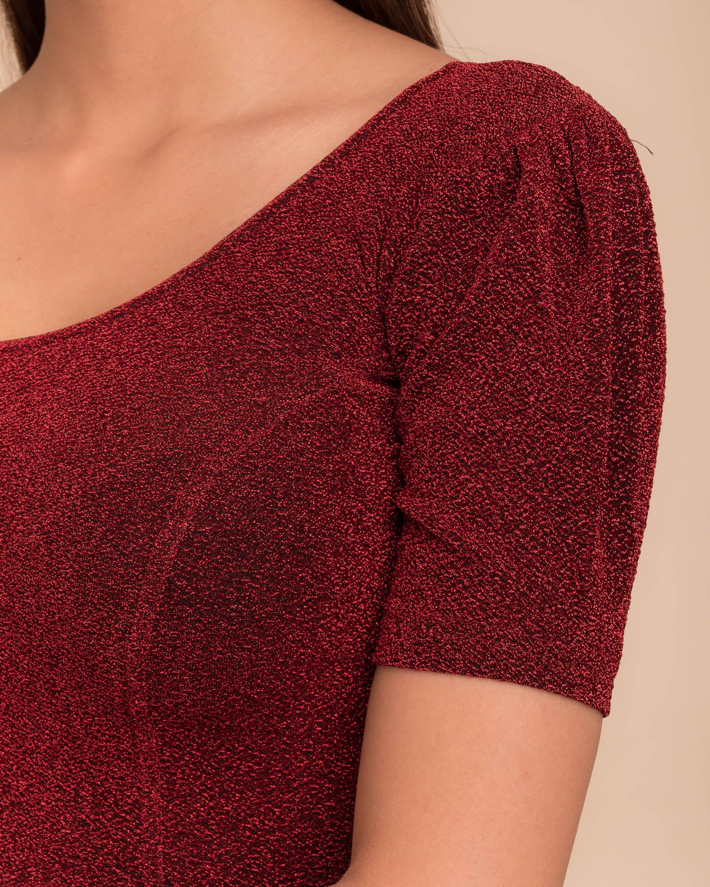 Close-up of the lurex fabric with fine pleating and subtle sheen