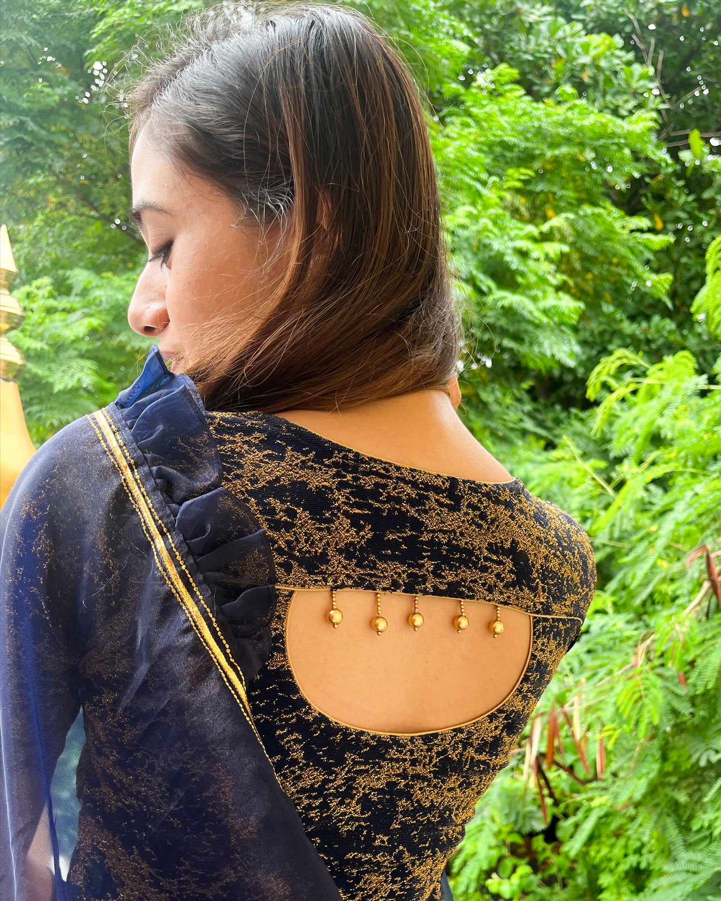Model pairing the blouse with an ethnic saree and lehenga to highlight the latkan detailing