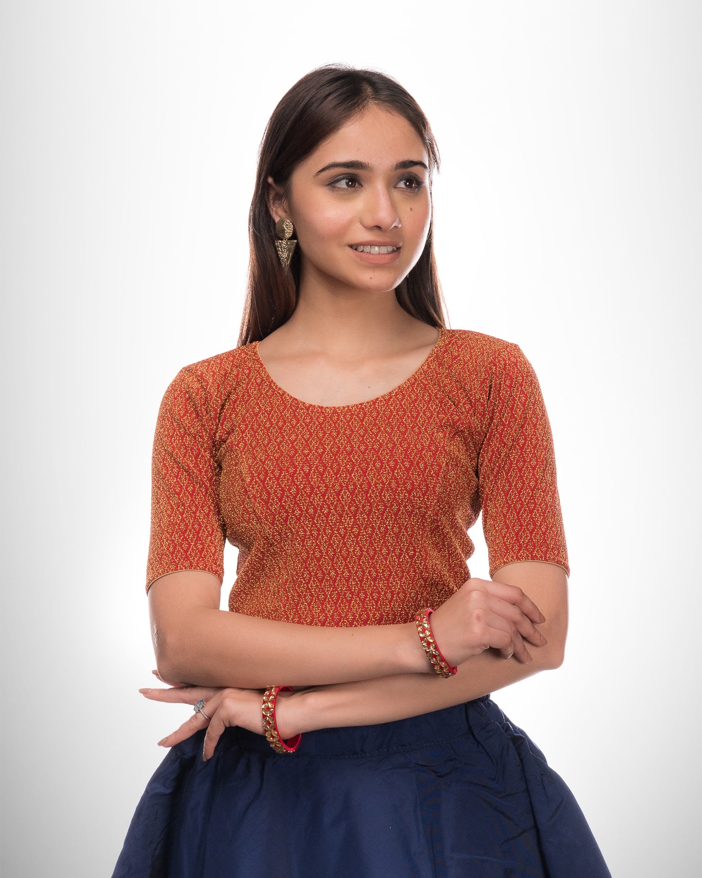 Model wearing a stretchable zari blouse with elbow sleeves and round neckline