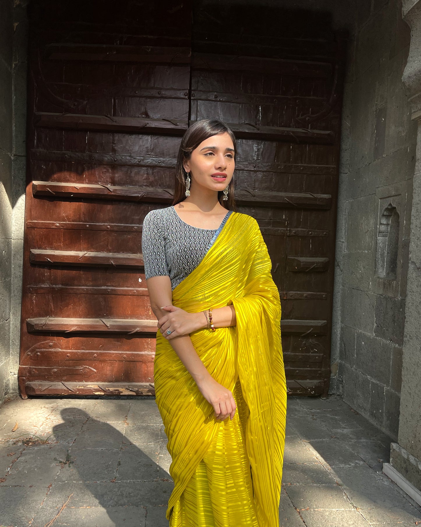 Model pairing the blouse with an ethnic saree and lehenga to highlight the latkan detailing