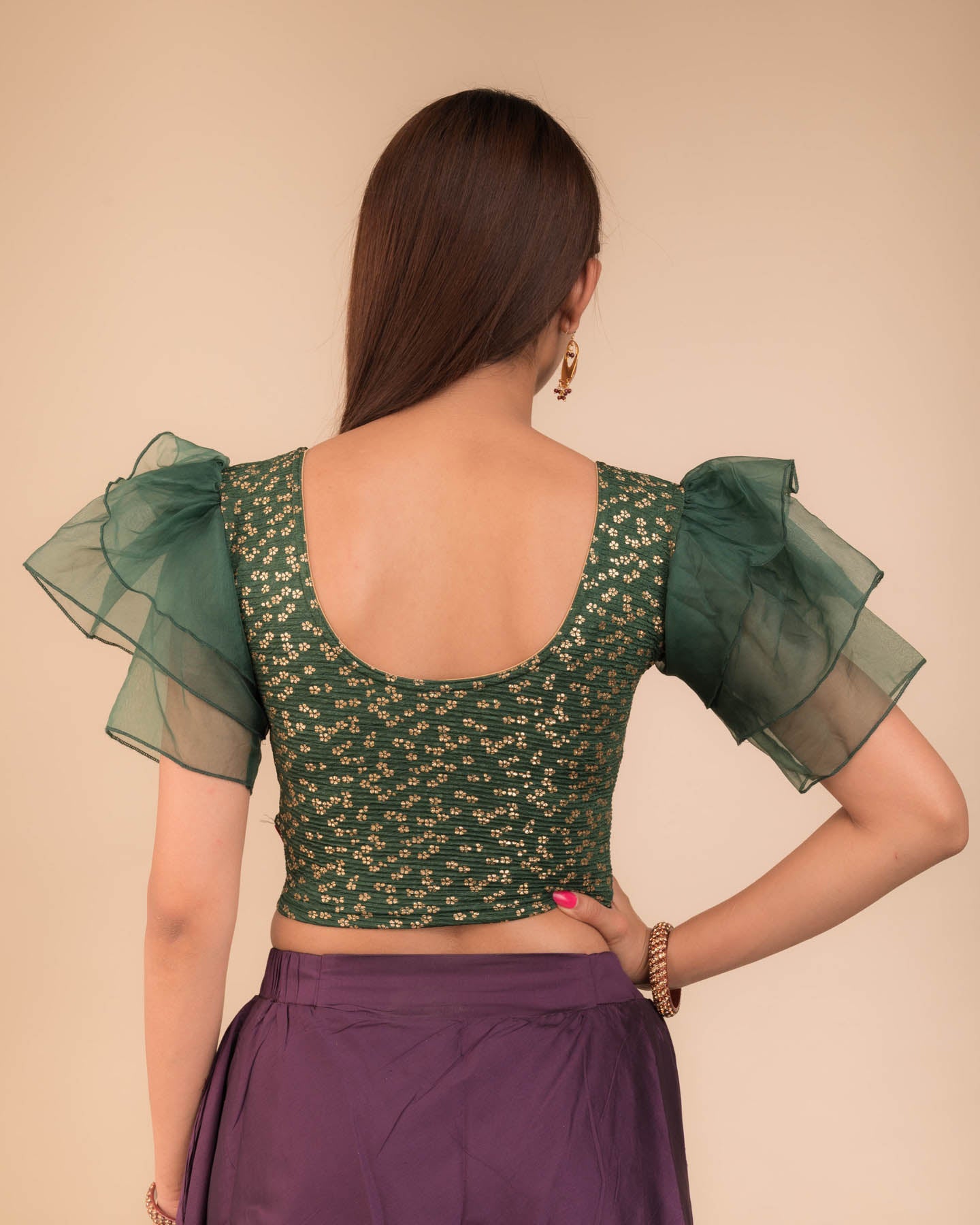 Rear view showcasing the layered ruffle sleeve design