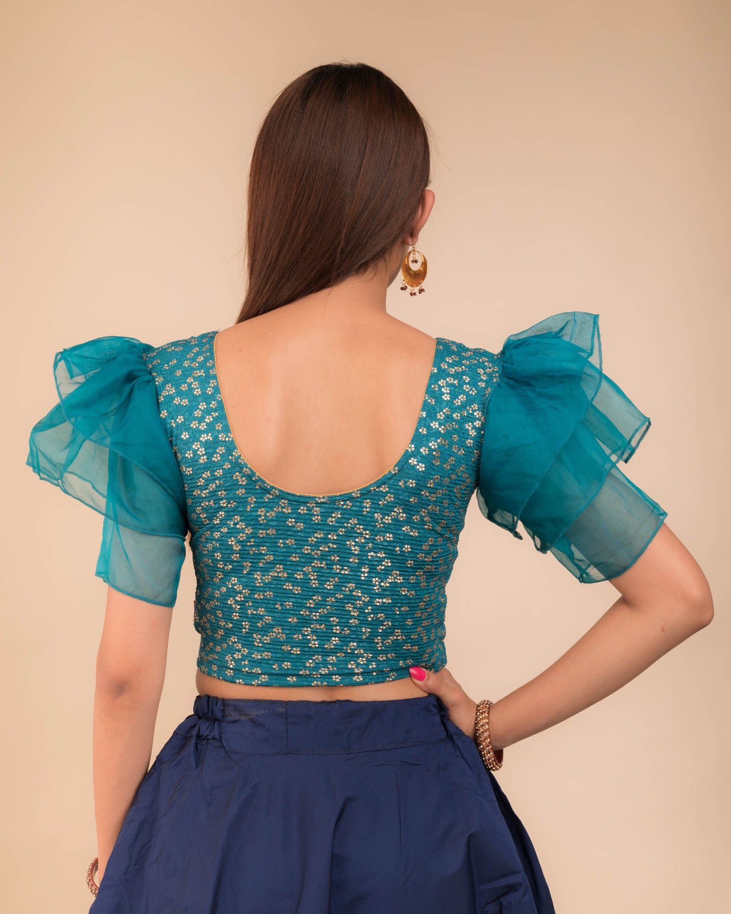 Rear view showcasing the layered ruffle sleeve design