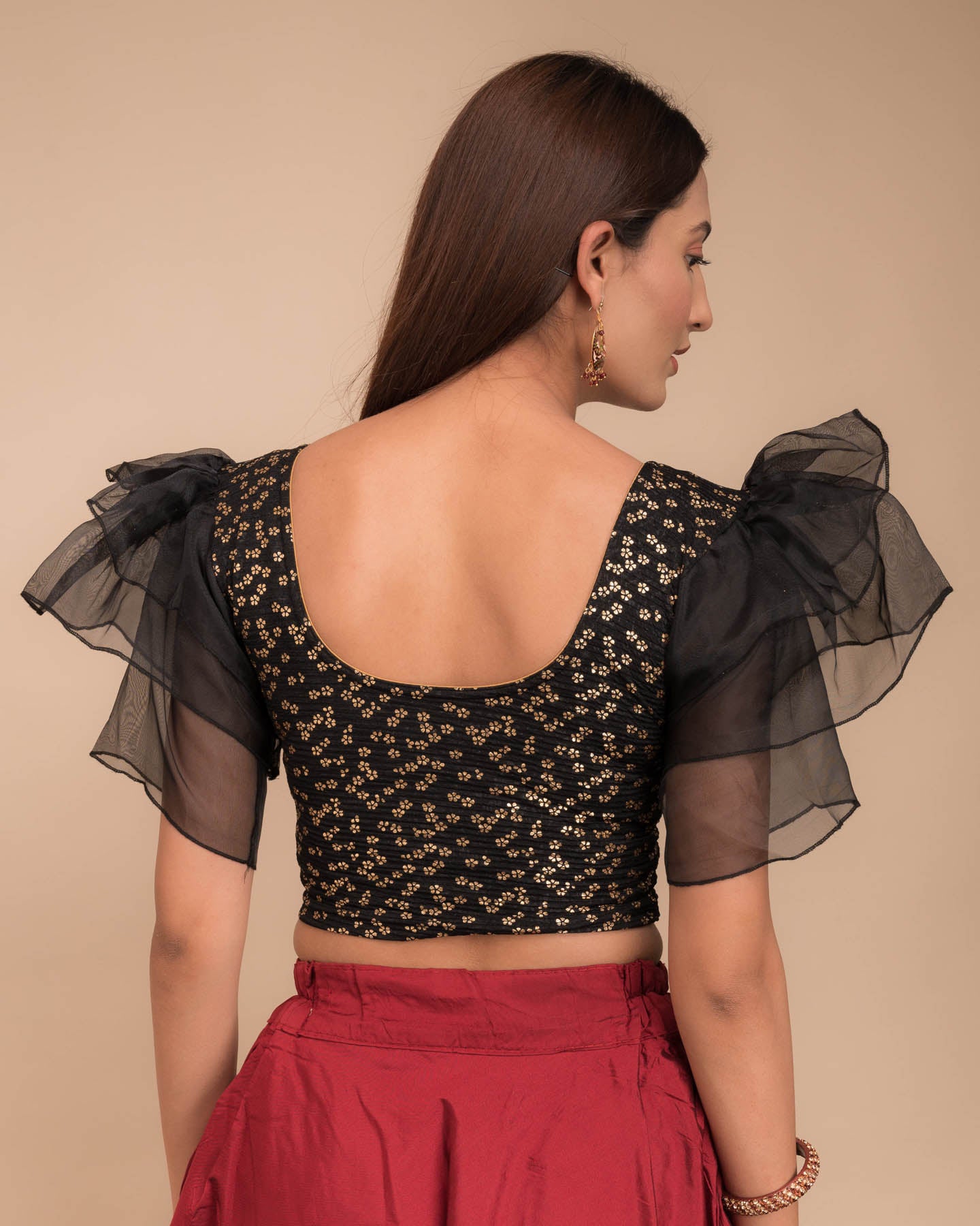 Rear view showcasing the layered ruffle sleeve design