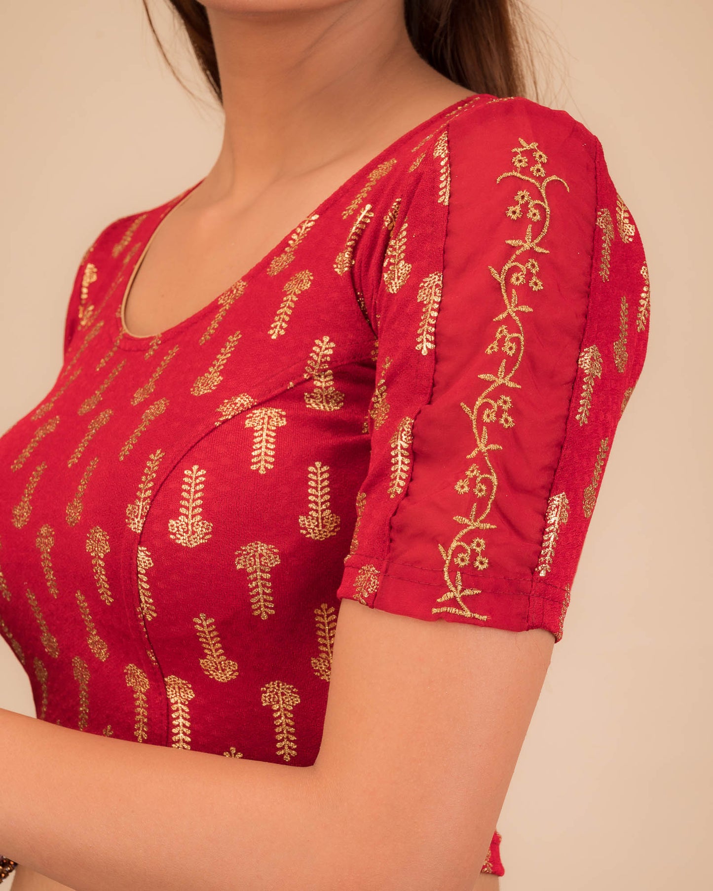 Close-up of the knit fabric with metallic print and intricate zari embroidery
