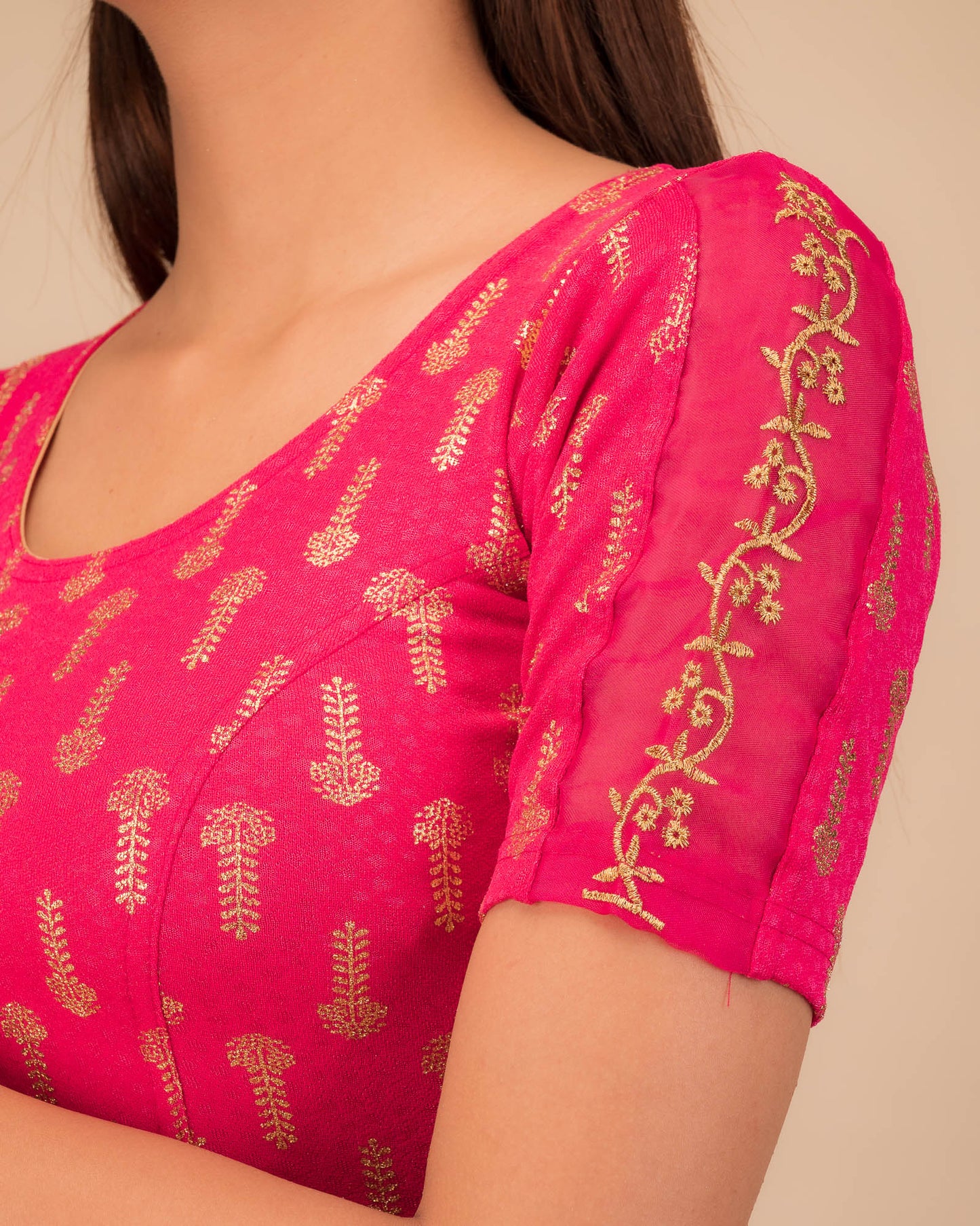 Close-up of the knit fabric with metallic print and intricate zari embroidery