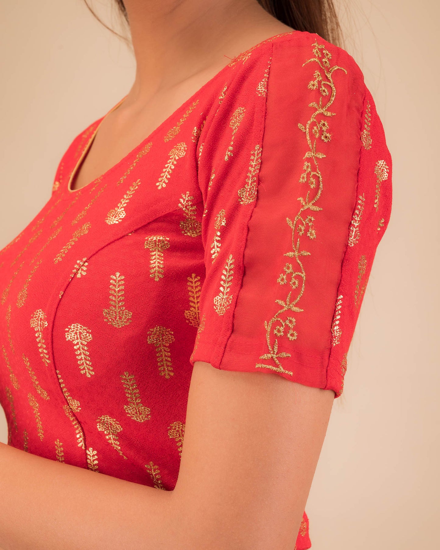 Close-up of the knit fabric with metallic print and intricate zari embroidery