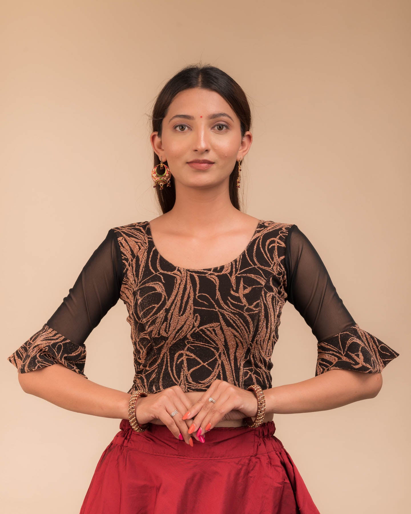 Model wearing a stretchable blouse featuring tonal zari flower appliqués, round neckline, and elbow sleeves