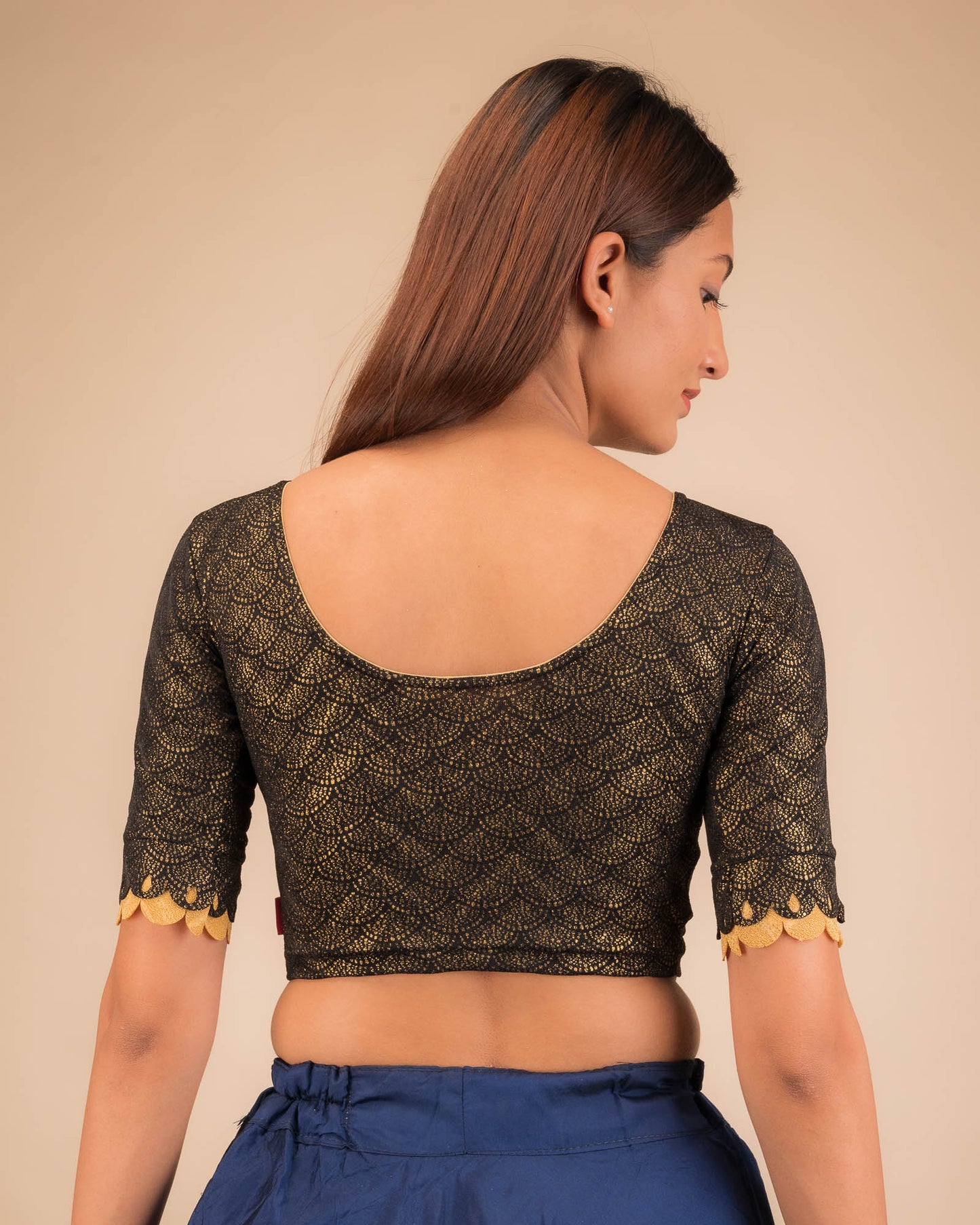 Rear view highlighting the scallop sleeve detail.
