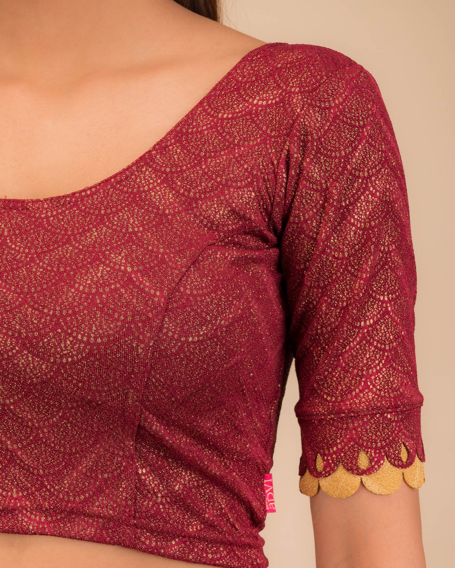 Close-up of the jacquard knit fabric with metallic scallop detailing.