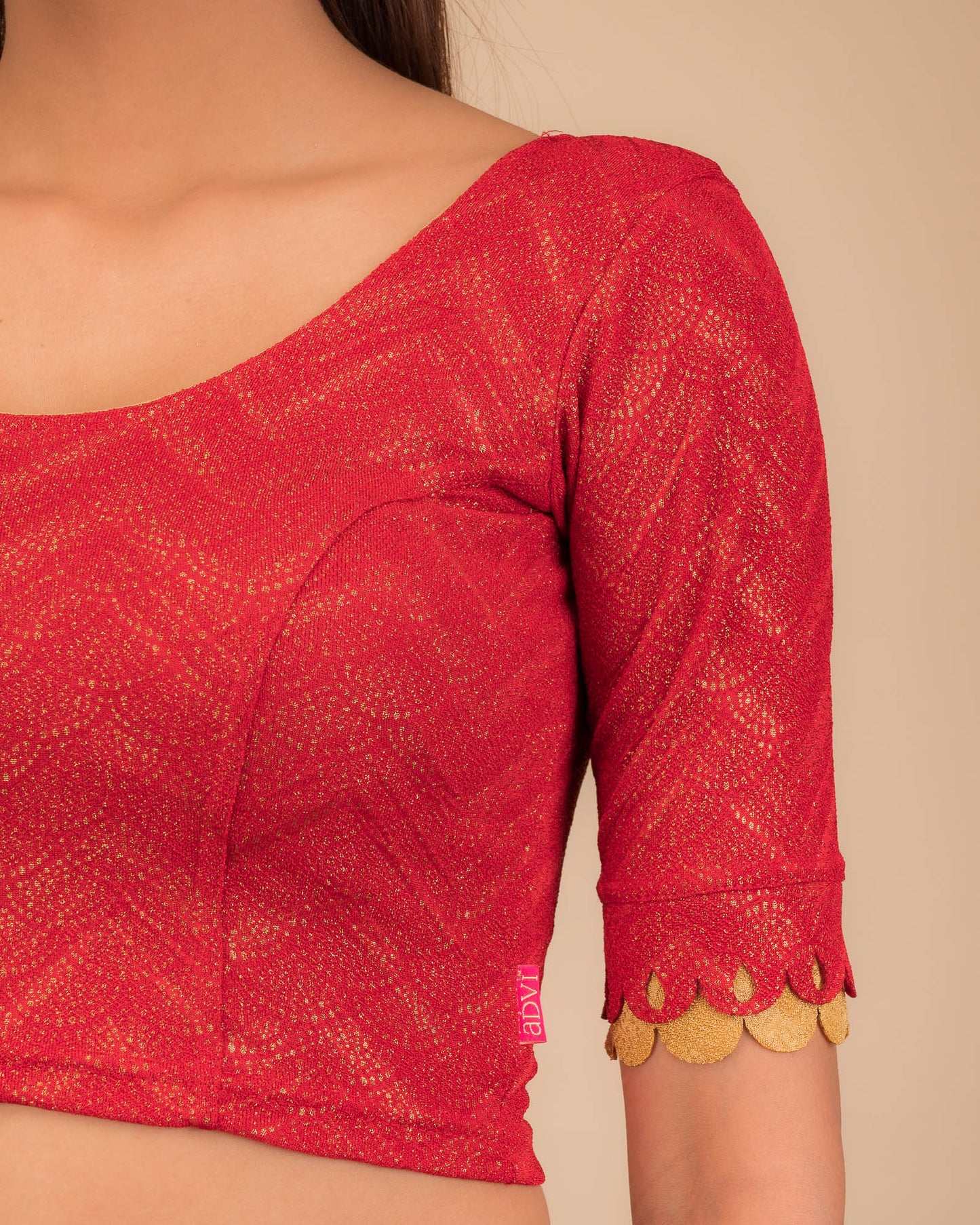 Close-up of the jacquard knit fabric with metallic scallop detailing.