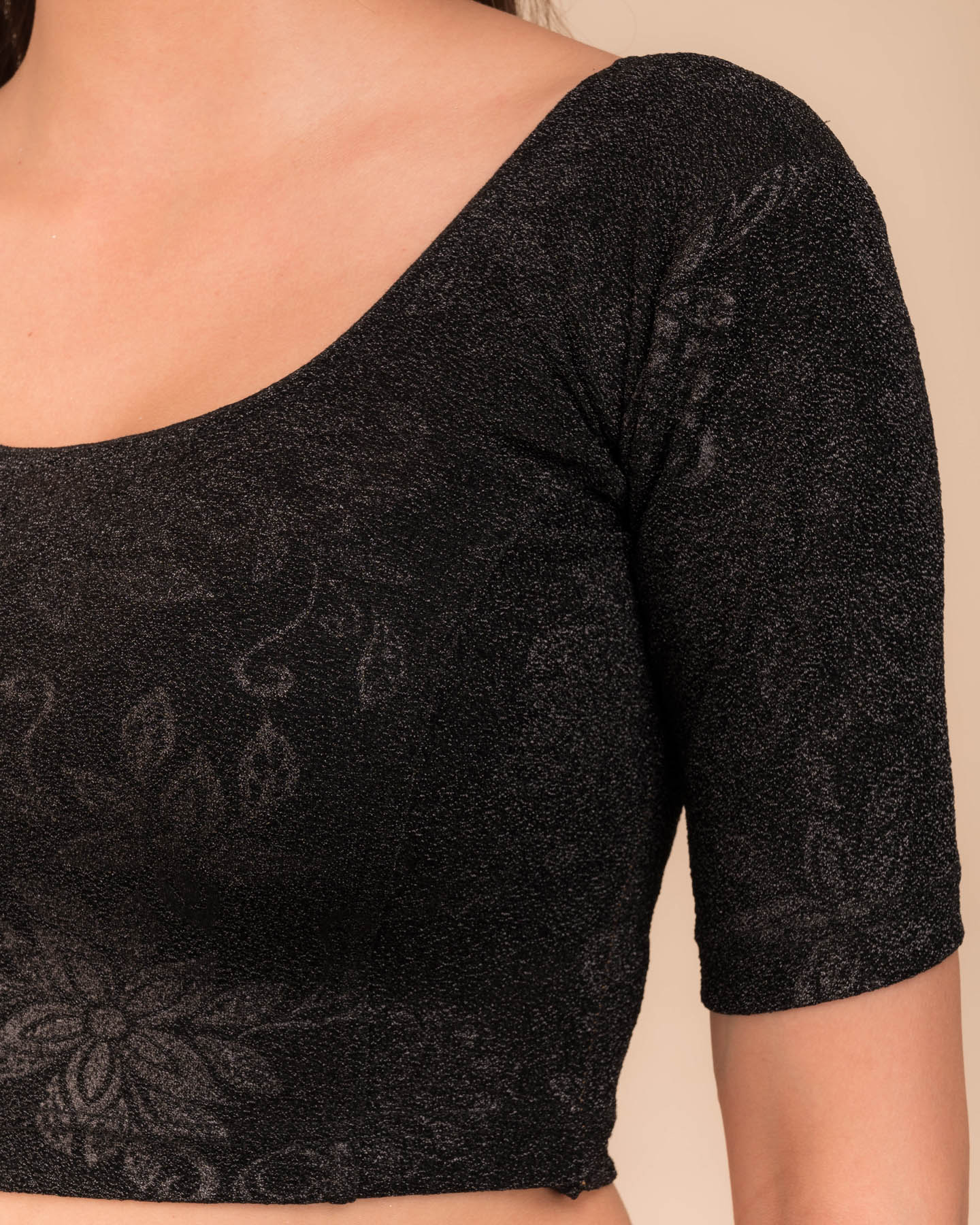 Close-up of the embossed metallic texture on stretchable knit fabric.