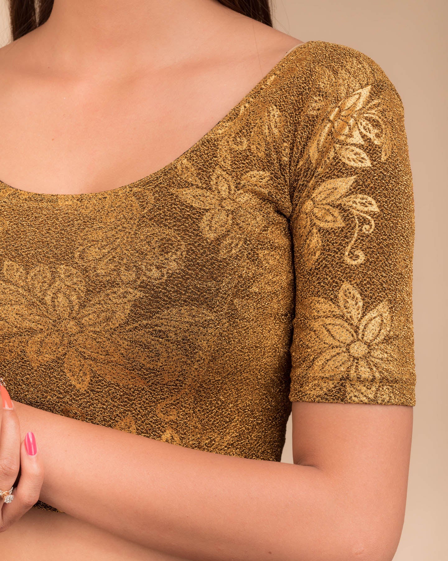 Close-up of the embossed metallic texture on stretchable knit fabric.