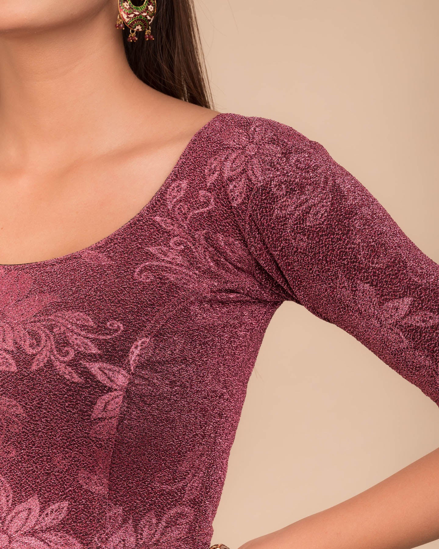 Close-up of the embossed metallic texture on stretchable knit fabric.
