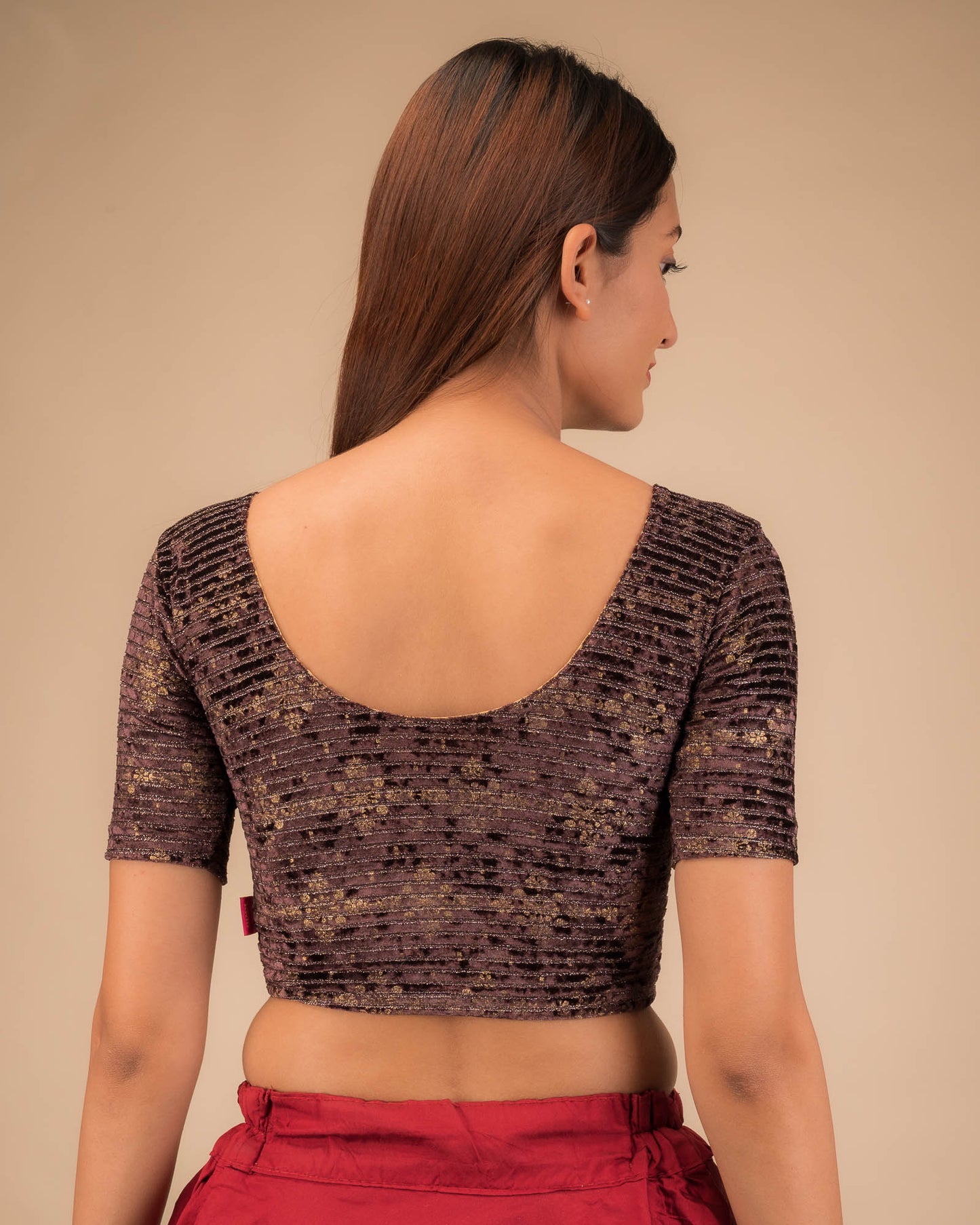 Rear view of the stretchable velvet blouse showcasing the back design.