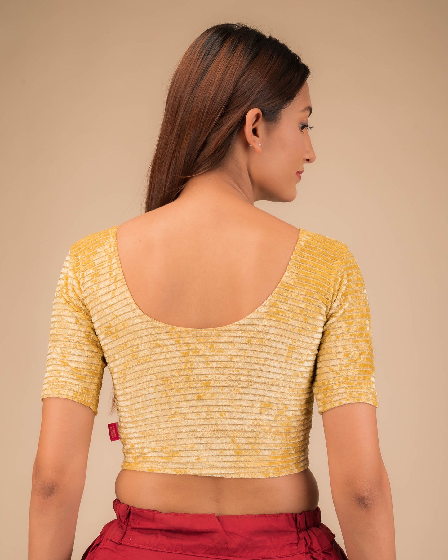 Rear view of the stretchable velvet blouse showcasing the back design.