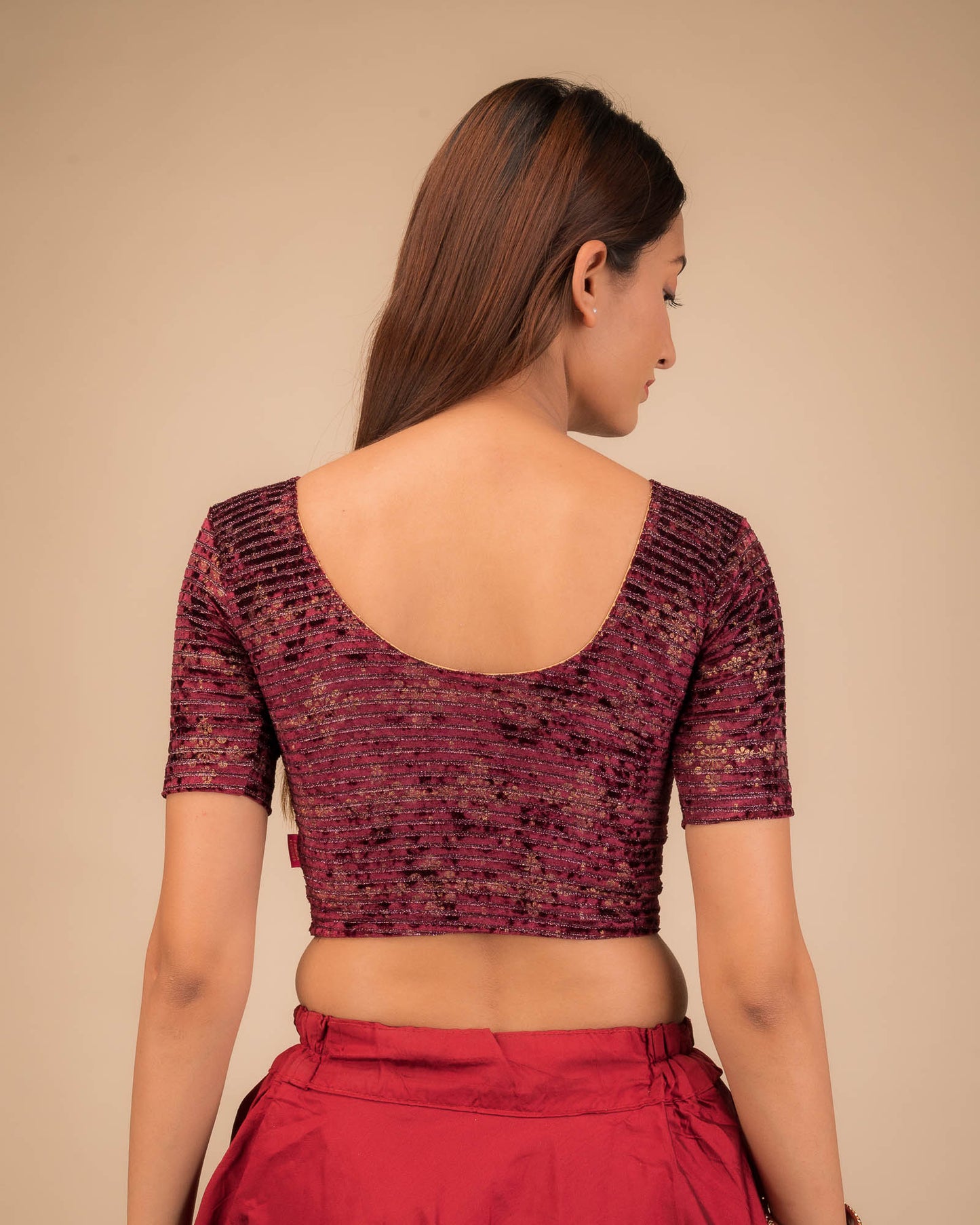 Rear view of the stretchable velvet blouse showcasing the back design.