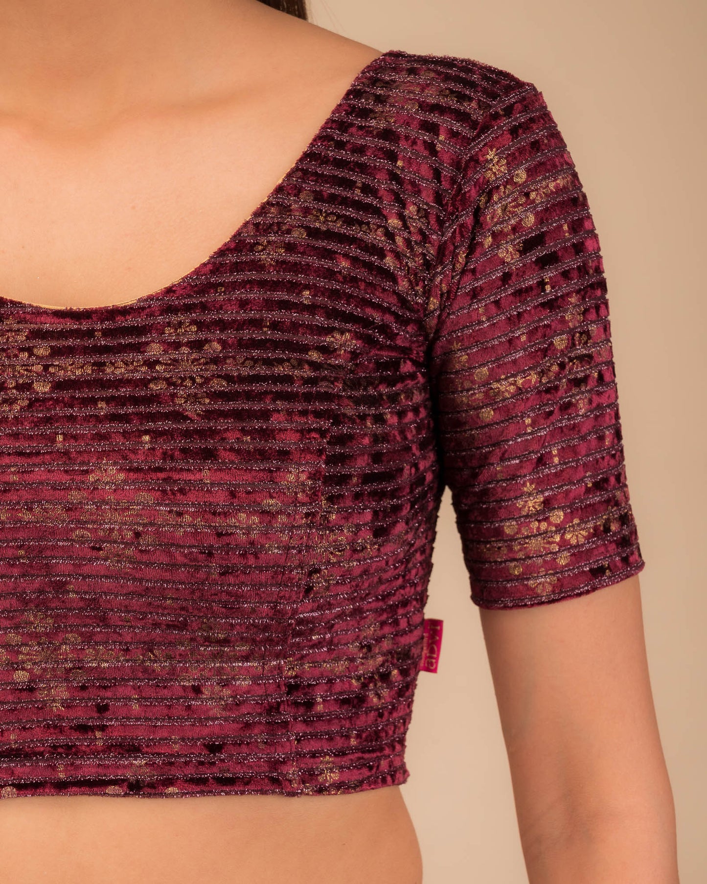 Close-up of velvet fabric with metallic foil embellishment.
