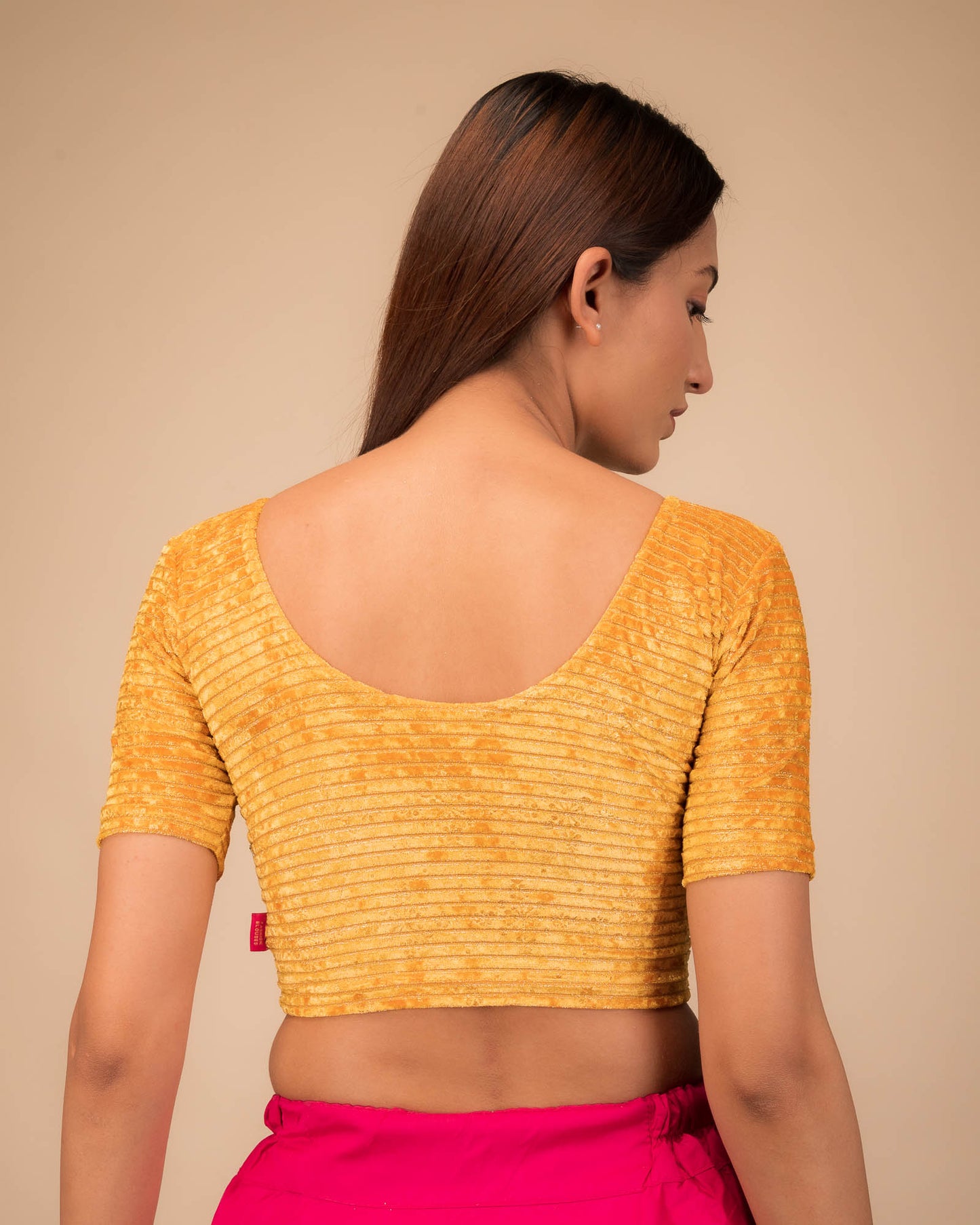 Rear view of the stretchable velvet blouse showcasing the back design.